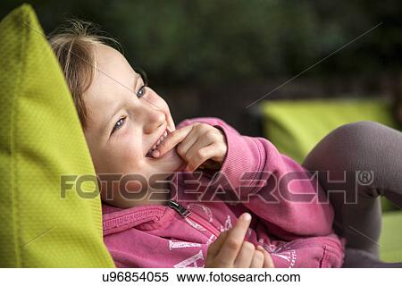 Girl lying on sun lounger View Large Photo Image Stock Photography - Girl lying on sun lounger. Fotosearch