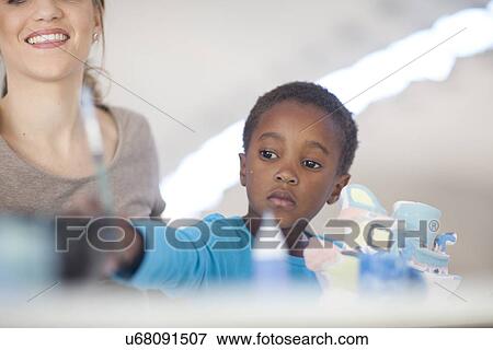 Girl painting in art class View Large Photo Image Stock Photo - Girl painting in art class. Fotosearch