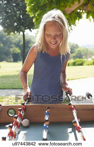 Girl playing foosball View Large Photo Image Stock Image - Girl playing foosball. Fotosearch