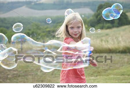 Girl playing with soap bubbles View Large Photo Image Stock Image - Girl playing with soap bubbles. Fotosearch