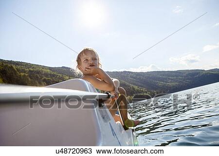 Girl sitting on steps of boat with hand on chin View Large Photo Image Stock Image - Girl sitting on steps of boat with hand on chin. Fotosearch