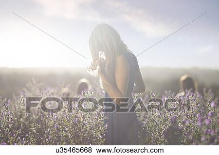 Girl standing on meadow View Large Photo Image Stock Photo - Girl standing on meadow. Fotosearch