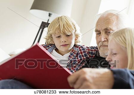Grandfather reading book to grandchildren View Large Photo Image Stock Image - Grandfather reading book to grandchildren. Fotosearch