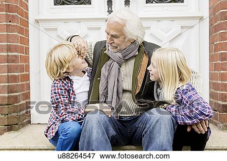 Grandfather sitting with grandchildren on front doorstep View Large Photo Image Stock Photo - Grandfather sitting with grandchildren on front doorstep. Fotosearch