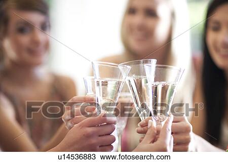 Group of female friends toasting with glass of champagne View Large Photo Image Stock Image - Group of female friends toasting with glass of champagne. Fotosearch