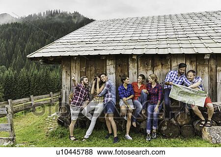 Group of friends chatting and reading map, Tirol, Austria View Large Photo Image Stock Photo - Group of friends chatting and reading map, Tirol, Austria. Fotosearch
