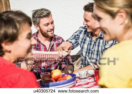 Group of friends enjoying breakfast together outdoors View Large Photo Image Picture - Group of friends enjoying breakfast together outdoors. Fotosearch