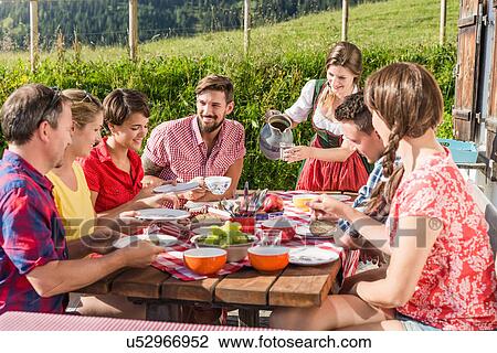 Group of friends enjoying breakfast, Tyrol, Austria View Large Photo Image Stock Image - Group of friends enjoying breakfast, Tyrol, Austria. Fotosearch