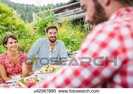 Group of friends having picnic lunch, Tyrol, Austria View Large Photo Image Stock Image - Group of friends having picnic lunch, Tyrol, Austria. Fotosearch