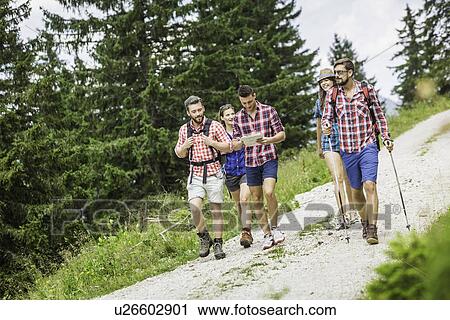 Stock Image - Group of friends hiking, Tyrol, Austria. Fotosearch