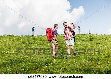 Stock Image - Group of friends hiking, Tyrol, Austria. Fotosearch