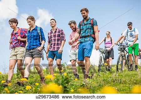 Stock Photograph - Group of friends hiking, Tyrol, Austria. Fotosearch