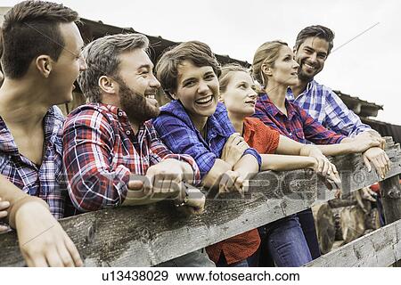 Group of friends leaning on wooden fence, Tirol, Austria View Large Photo Image Stock Photo - Group of friends leaning on wooden fence, Tirol, Austria. Fotosearch