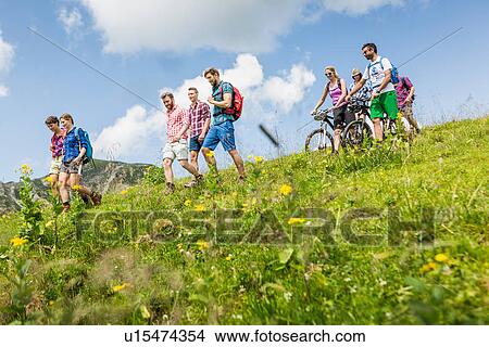 Group of friends mountain biking and hiking, Tyrol, Austria View Large Photo Image Picture - Group of friends mountain biking and hiking, Tyrol, Austria. Fotosearch