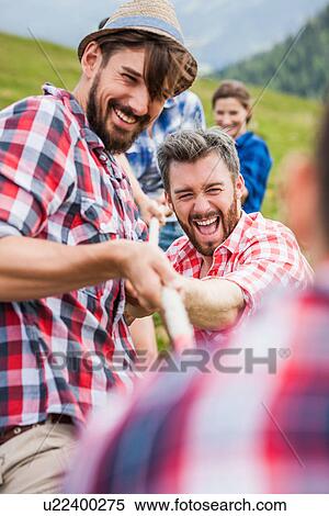 Group of friends playing tug of war View Large Photo Image Stock Photography - Group of friends playing tug of war. Fotosearch