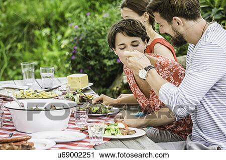 Group of friends sitting down to picnic lunch, Tyrol, Austria View Large Photo Image Stock Image - Group of friends sitting down to picnic lunch, Tyrol, Austria. Fotosearch