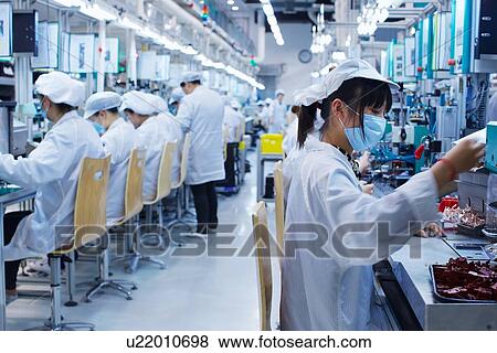 Group of workers at small parts manufacturing factory in China, wearing protective clothing, hats and masks View Large Photo Image Stock Photo - Group of workers at small parts manufacturing factory in China, wearing protective clothing, hats and masks. Fotosearch