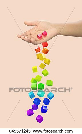 Stock Photography - Hand dropping multi coloured blocks. Fotosearch