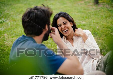 Stock Photograph - Happy couple on lawn. Fotosearch