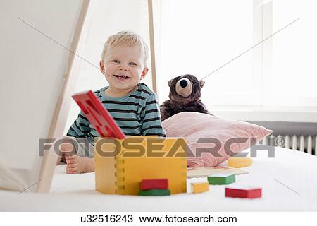 Stock Image - Happy little boy with toys. Fotosearch