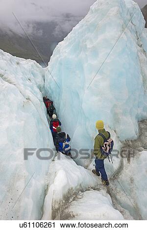 Stock Image - Ice climbers on Fox Glacier, South Island, New Zealand. Fotosearch
