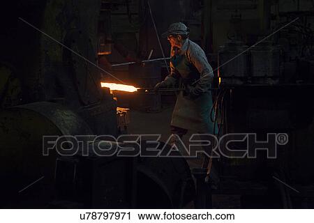 Inserting red hot steel billet into upset forge View Large Photo Image Stock Image - Inserting red hot steel billet into upset forge. Fotosearch