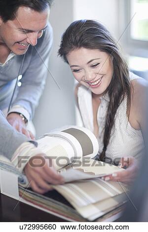 Interior designer and client looking at design catalogue View Large Photo Image Stock Image - Interior designer and client looking at design catalogue. Fotosearch