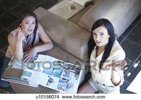 Interior designer and client with scrap book View Large Photo Image Picture - Interior designer and client with scrap book. Fotosearch