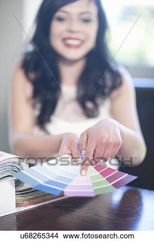 Interior designer pointing at textile swatches View Large Photo Image Picture - Interior designer pointing at textile swatches. Fotosearch