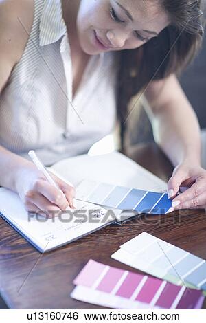 Interior designer with swatches writing in diary View Large Photo Image Stock Photograph - Interior designer with swatches writing in diary. Fotosearch