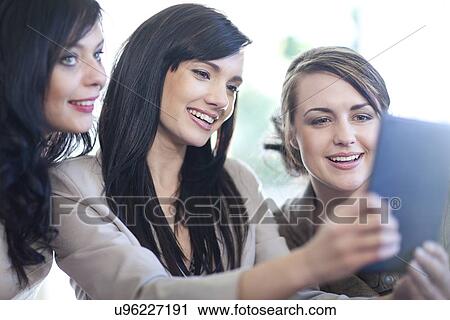Interior designers and client looking at digital tablet View Large Photo Image Stock Image - Interior designers and client looking at digital tablet. Fotosearch