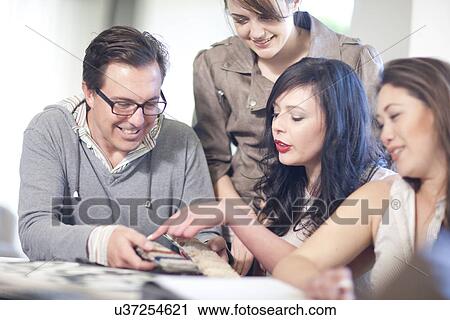 Interior designers looking at textile swatches View Large Photo Image Stock Image - Interior designers looking at textile swatches. Fotosearch