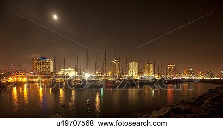 Stock Photo - Israel, Tel Aviv skyline and yacht marina at night as seen from west. Fotosearch