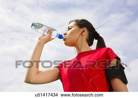 Picture - Jogger having drink of water. Fotosearch