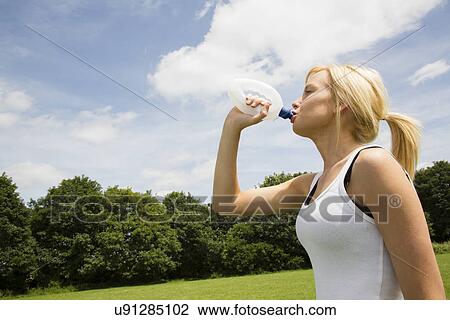 Stock Image - Jogger having drink of water. Fotosearch