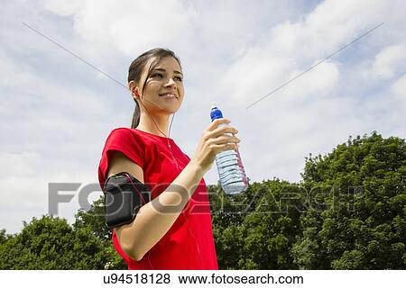 Stock Photo - Jogger having drink of water. Fotosearch