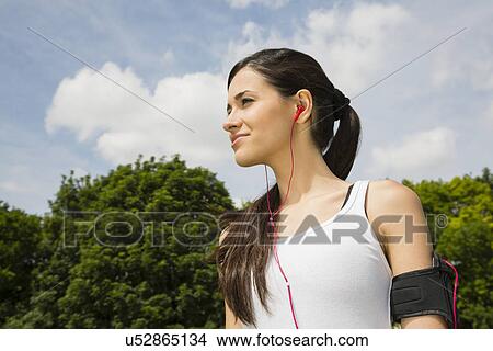 Jogger listening to mp3 player with earphones View Large Photo Image Picture - Jogger listening to mp3 player with earphones. Fotosearch