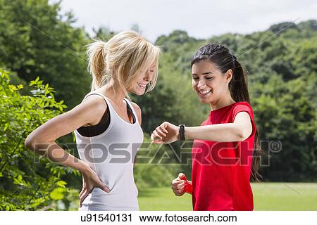 Stock Image - Joggers checking the time. Fotosearch
