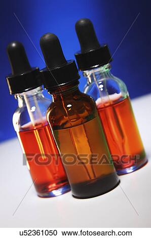 Stock Image - Liquid chemicals in dropper bottles. Fotosearch