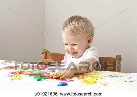 Little boy playing with finger paints View Large Photo Image Stock Photograph - Little boy playing with finger paints. Fotosearch