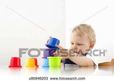 Little boy playing with stacking cups View Large Photo Image Stock Image - Little boy playing with stacking cups. Fotosearch