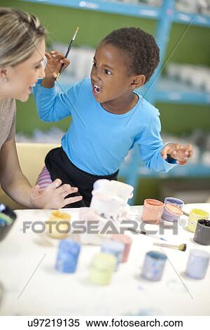 Little girl playing with teacher in class View Large Photo Image Stock Photography - Little girl playing with teacher in class. Fotosearch