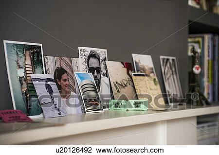 Stock Image - Living room mantelpiece with travel souvenirs and photographs. Fotosearch