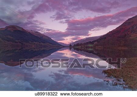 Stock Image - Loch Voil at dawn, in the Loch Lomond and Trossachs National Park in Scotland. Fotosearch