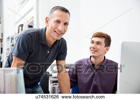 Male colleagues in office View Large Photo Image Stock Photograph - Male colleagues in office. Fotosearch