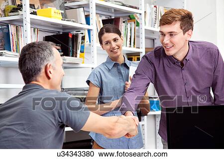 Male colleagues shaking hands View Large Photo Image Stock Image - Male colleagues shaking hands. Fotosearch