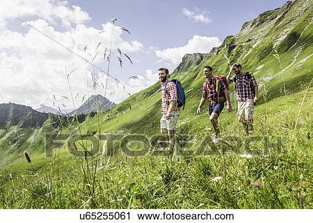 Stock Image - Male friends hiking, Tyrol, Austria. Fotosearch