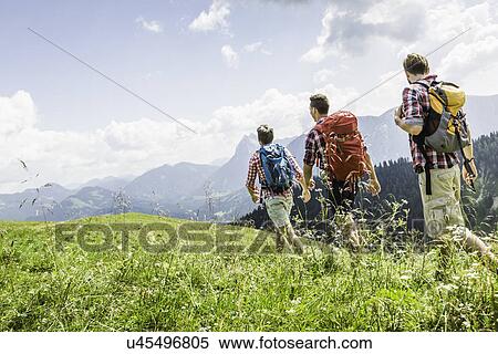 Stock Photography - Male friends hiking, Tyrol, Austria. Fotosearch