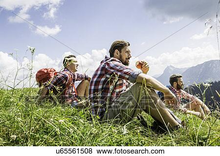 Male friends resting on hike, Tyrol, Austria View Large Photo Image Stock Photo - Male friends resting on hike, Tyrol, Austria. Fotosearch