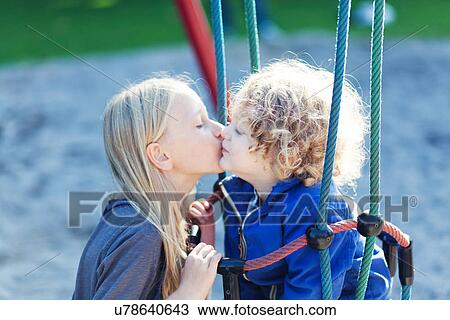 Male toddler and sister sharing a kiss in park View Large Photo Image Stock Image - Male toddler and sister sharing a kiss in park. Fotosearch
